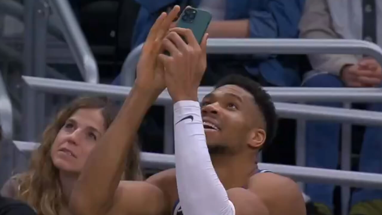 Giannis Antetokounmpo Scans QR Code With Mobile Phone To Get Free Chicken Wings From Wingstop